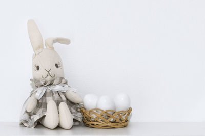 Close-up of figurines on table against white background