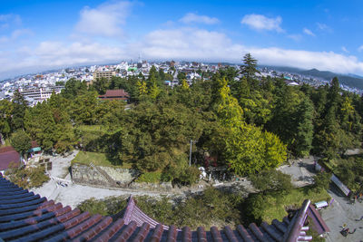 High angle view of trees and buildings against sky