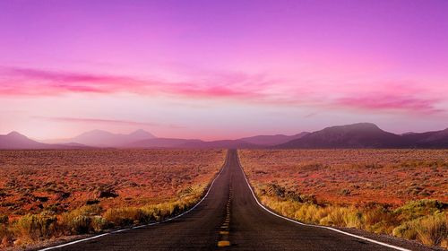 Road amidst landscape against sky during sunset