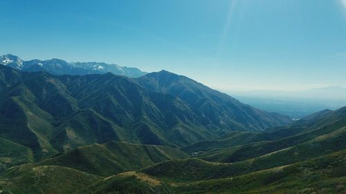 Scenic view of mountain range against blue sky