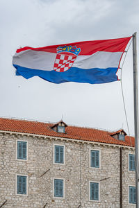 Low angle view of flag against building