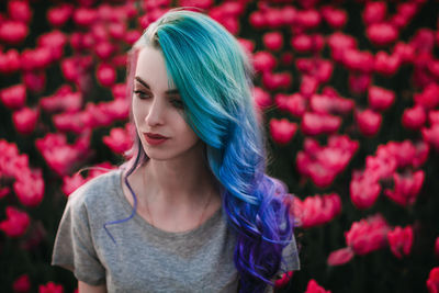 Portrait of beautiful woman with red flower