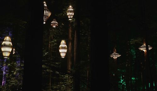 Low angle view of illuminated pendant lights hanging from ceiling in building