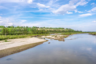 Summer scenic views of at lake against sky at the glenmore reservoir in calgary, alberta.