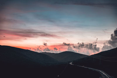 Scenic view of silhouette mountains against sky during sunset