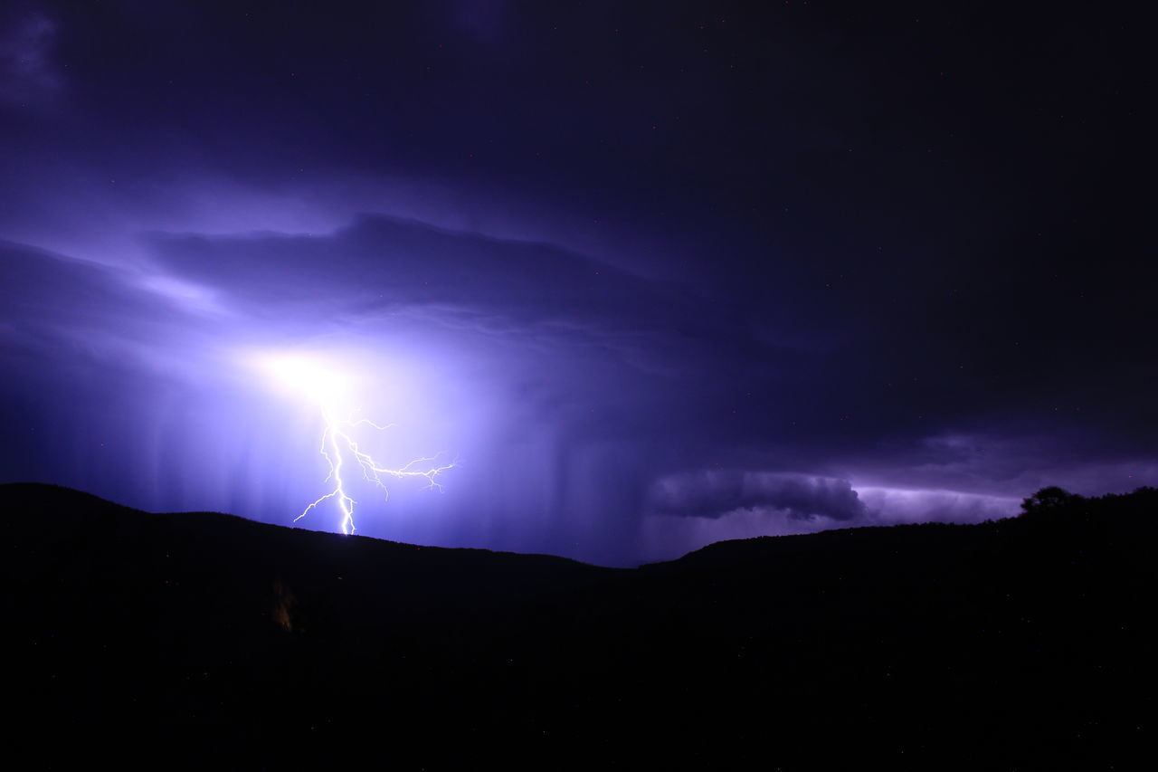lightning, power in nature, storm, thunderstorm, cloud, beauty in nature, night, sky, thunder, environment, dramatic sky, darkness, warning sign, mountain, storm cloud, scenics - nature, nature, sign, communication, no people, dark, forked lightning, silhouette, landscape, outdoors, purple, awe, illuminated, light - natural phenomenon