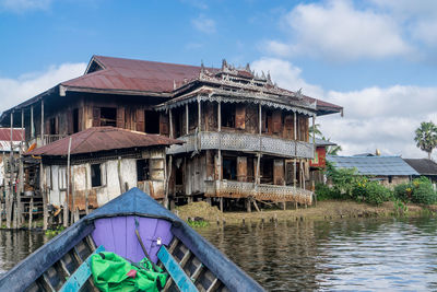 Building by river against sky