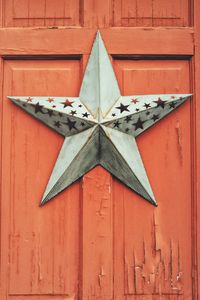 Full frame shot of star on red wooden door