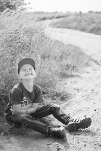 Portrait of boy sitting on grass