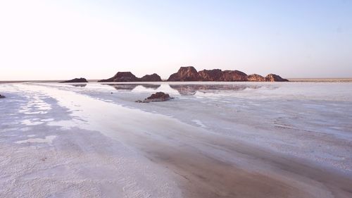 Scenic view of beach against clear sky