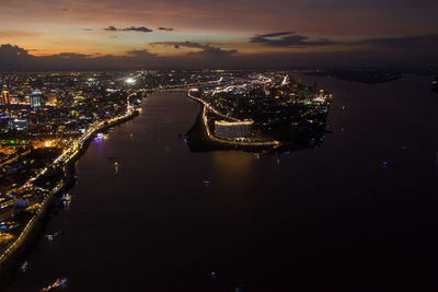 High angle view of city lit up at night