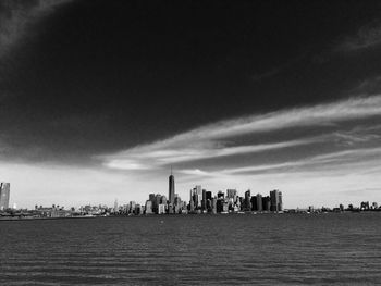 Cityscape by east river against sky
