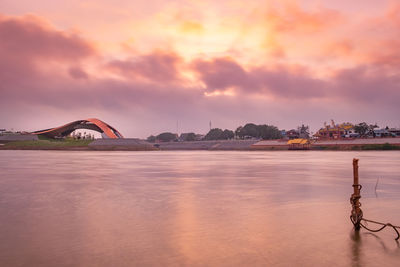 Scenic view of river against sky during sunset