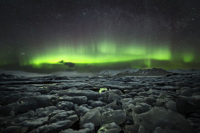 Scenic view of landscape against sky at night