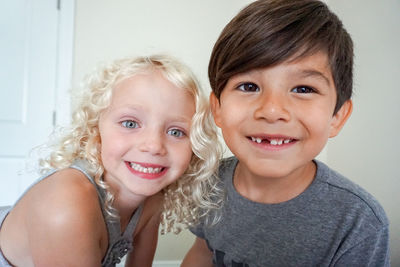 Boy and girl staring at camera closeup smiling