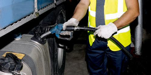 Midsection of man repairing car