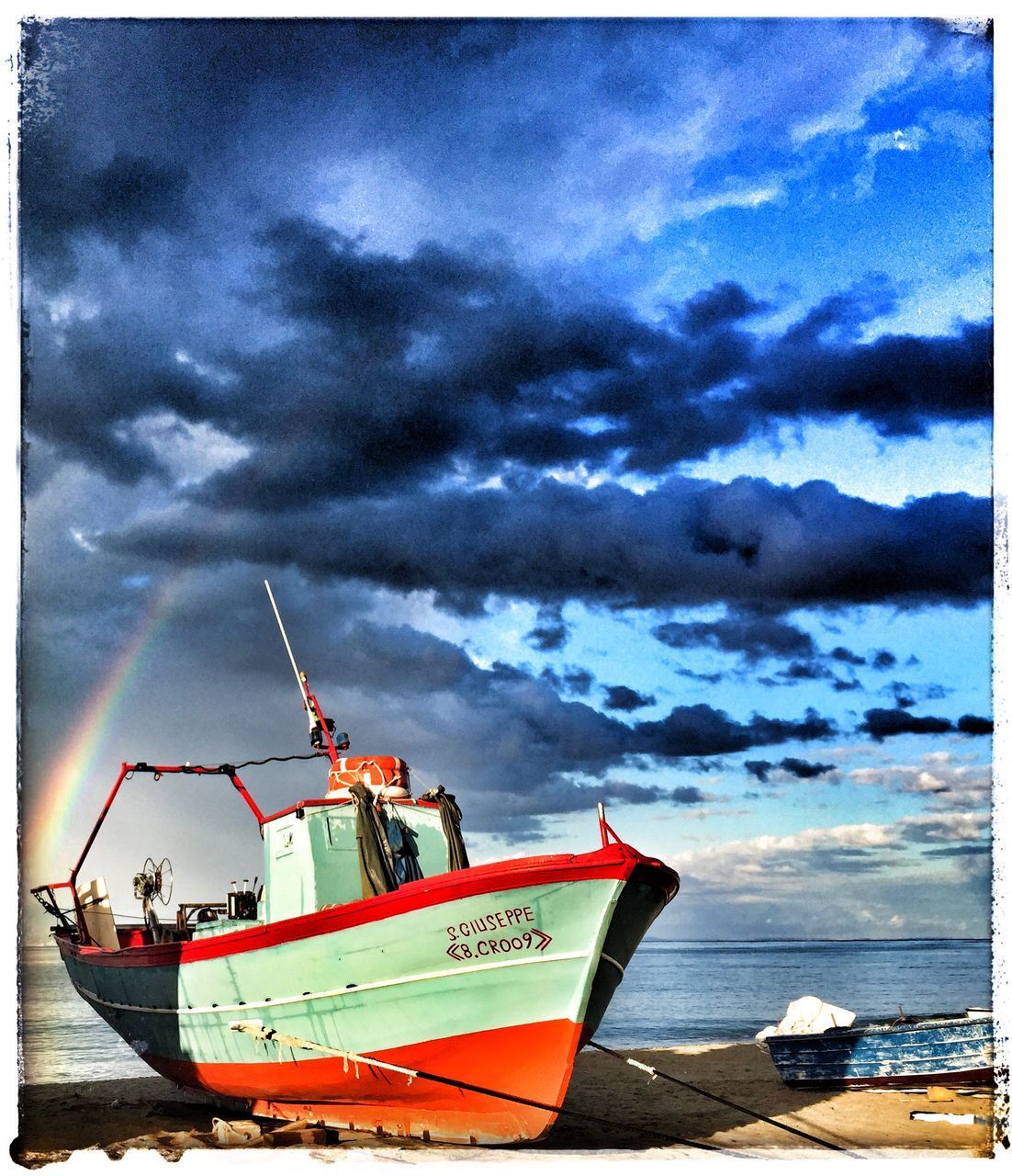 FISHING BOATS MOORED ON SEA AGAINST SKY