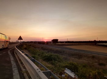 Train on railway tracks against sky during sunset