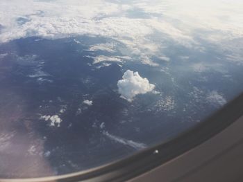 Aerial view of landscape seen through airplane window