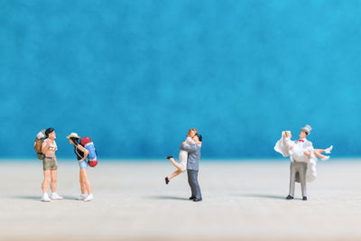 Group of people on sand against sky