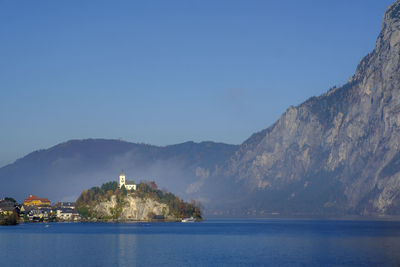 Scenic view of sea and buildings against sky