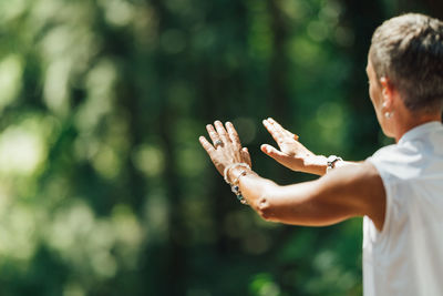 Woman practicing tai chi chuan outdoors. close up on hand position