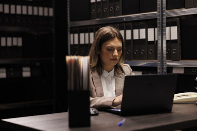 Young woman using laptop at table