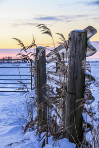 Built structure by sea against sky during winter