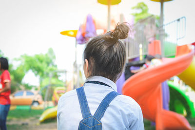 Rear view of girl at park