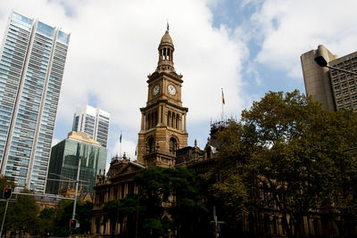 Low angle view of buildings against cloudy sky