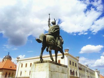 Low angle view of statue against cloudy sky