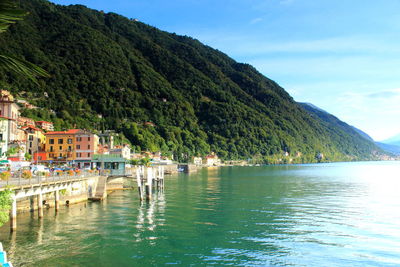 Scenic view of sea by buildings against sky