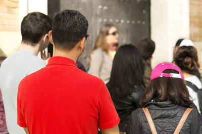 Tour guide with tourist group in city street