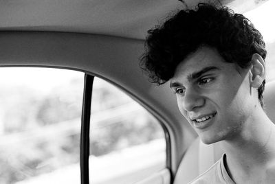 Smiling young man in car