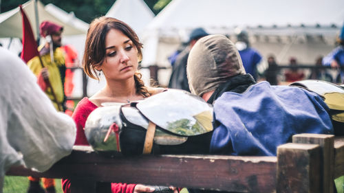 Woman looking at friend in costume during event