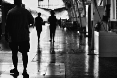 Rear view of people walking on street