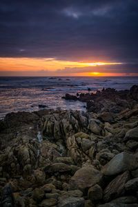 Beautiful sunset rock beach landscape peaceful relaxing with waves crashing atlantic ocean in spain