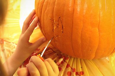 Close-up of cropped hand holding apple