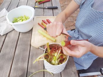 High angle view of woman preparing food on table