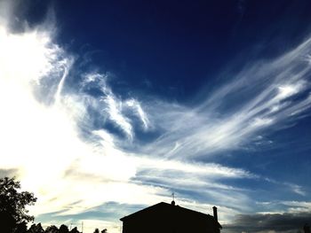 Low angle view of silhouette building against sky