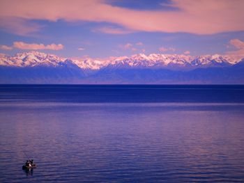 Scenic view of lake against cloudy sky