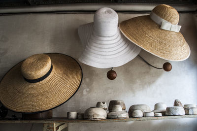 Straw hats hanging on wall at store