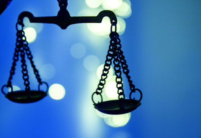 Low angle view of decorations hanging against clear blue sky