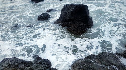 High angle view of rocks in sea