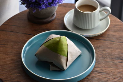 High angle view of coffee and cup on table