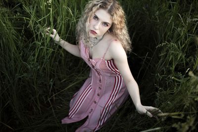 Portrait of beautiful young woman lying on land