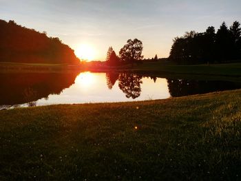 Scenic view of lake at sunset