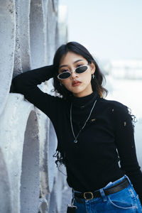 Young woman wearing sunglasses standing outdoors