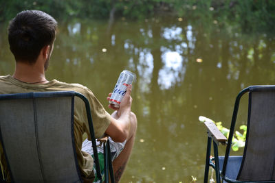 Rear view of man using mobile phone