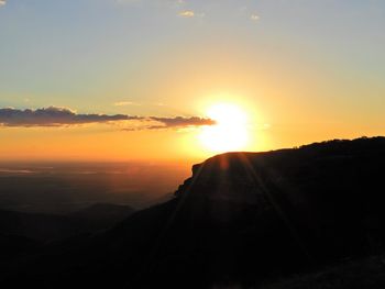 Scenic view of silhouette mountains against sky during sunset